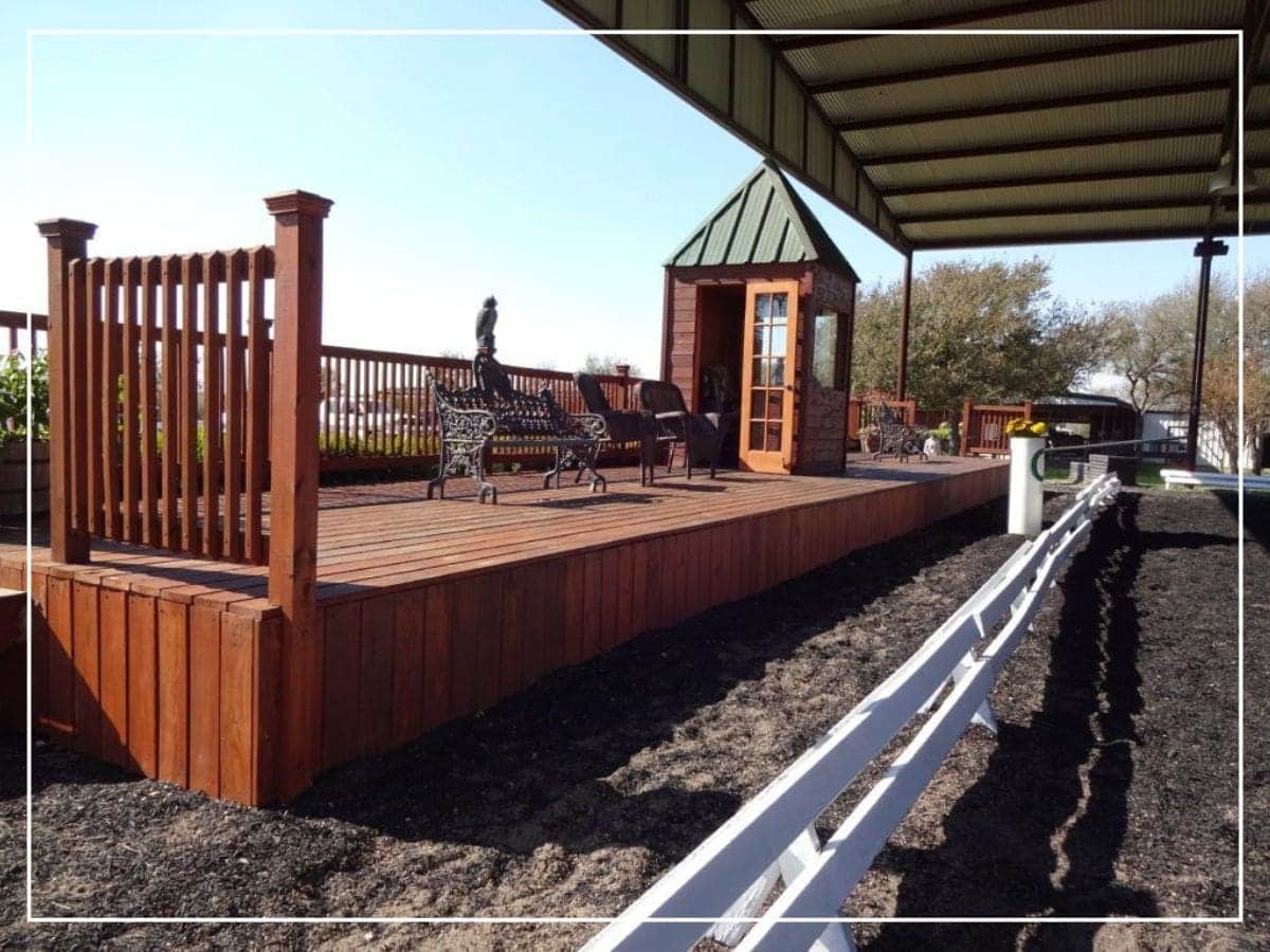 A wooden stage with benches and a bench on the side.