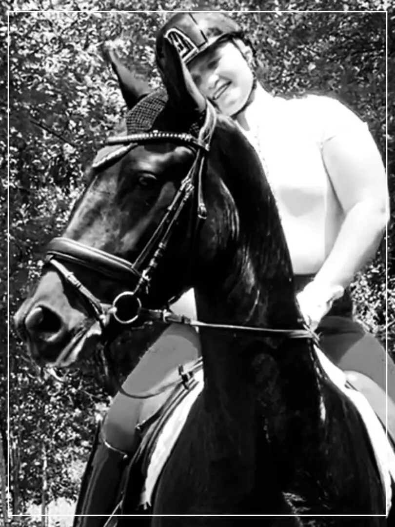 A woman riding on the back of a horse.