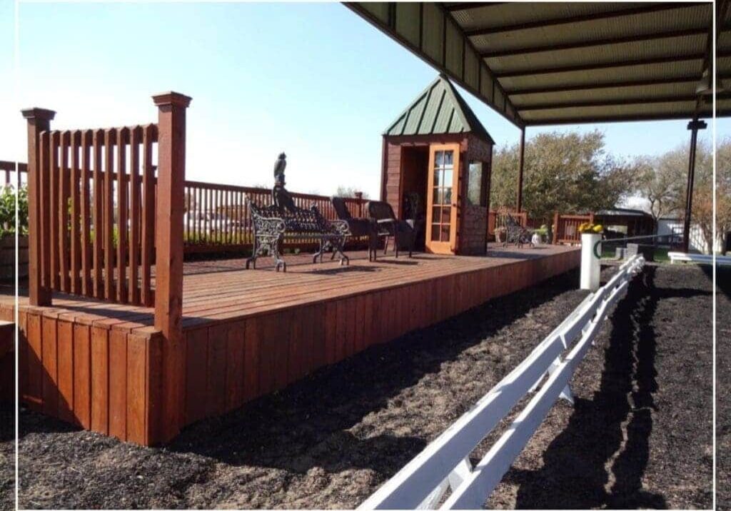 A wooden stage with benches and a bench on the side.